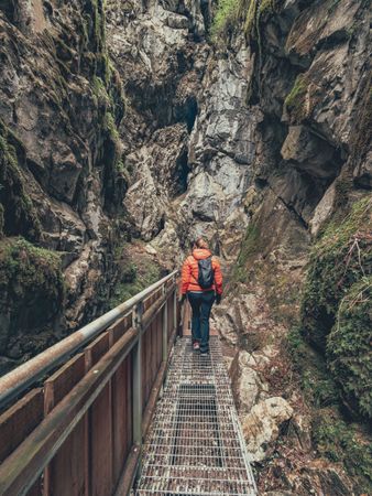 Traveller admiring picturesque view of mountain ridge