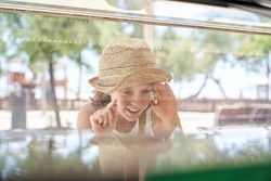 Excited child near showcase of ice cream parlor