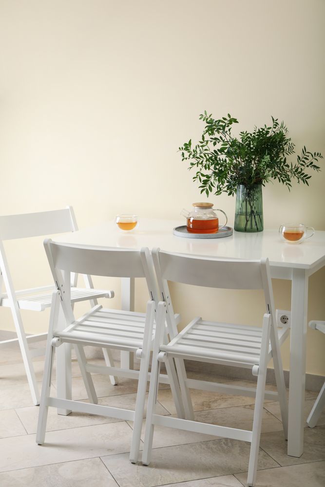 kitchen table with tea and plant in bright room
