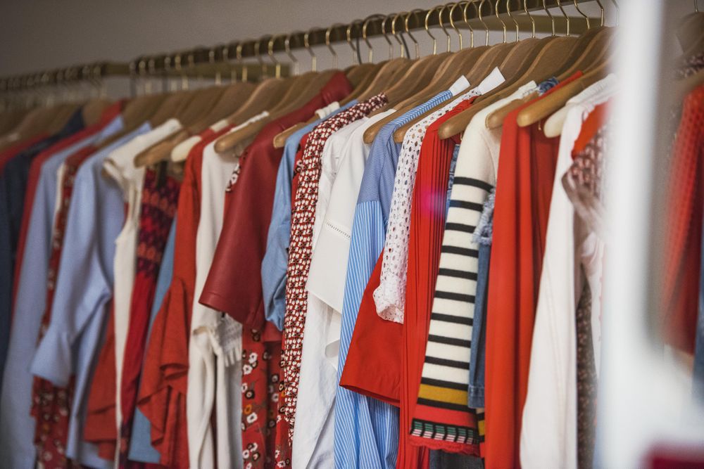Light and red shirts on a hanger in fashion store