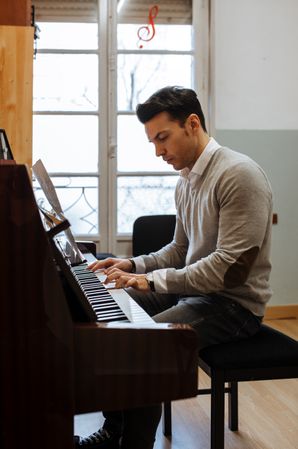 Man playing piano in studio