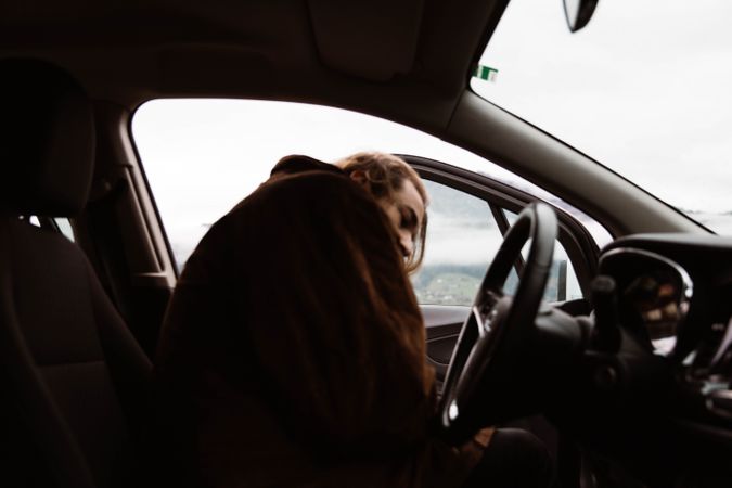 Cold male traveler sitting in car