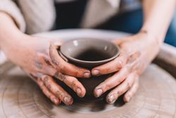 Crop potter shaping vessel on wheel