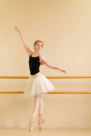Ballet dancer performs elegant stretch on pointe
