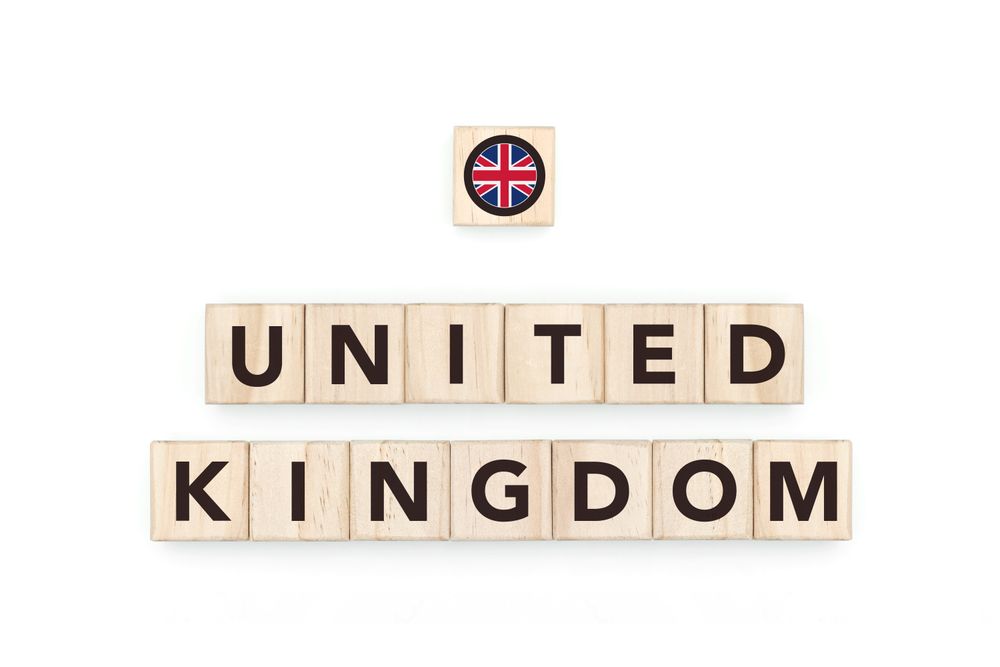 Wooden blocks bearing the name and flag of United Kingdom. British and European Culture, national identity, travel, and geography in a copy space design.