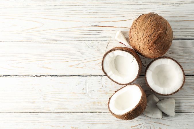 Coconut on wooden background, top view. Tropical fruit