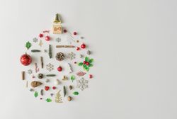 Christmas bauble made of various winter and holiday objects on light paper