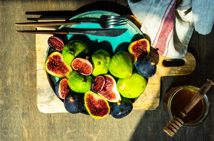 Freshly picked figs on a plate in a sunny kitchen