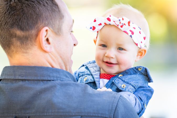 Young Father and Baby Girl At The Park