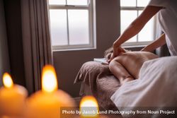 Professional beautician massaging female back beXrzp