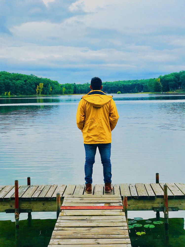 Backview of a man standing on wooden dock in Baldwin, Michigan, United States