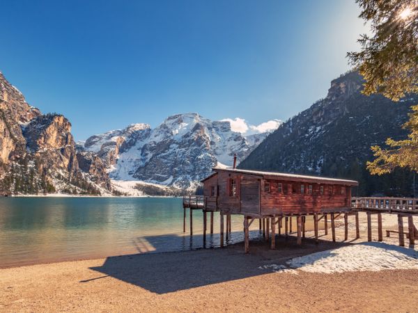 Wooden house on stilts on serene lake