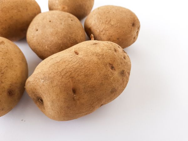 Close-Up of Raw Potatoes on Plain Background