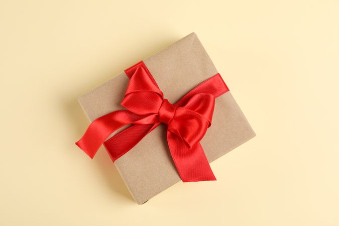 Gift box with bow on color background, space for text