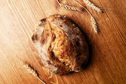 Top view of round loaf of bread with wheat chaff