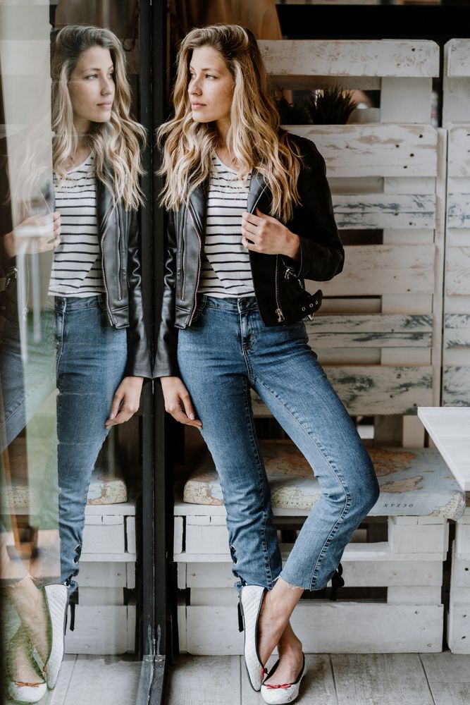 Casual stylish woman standing at table in cafe