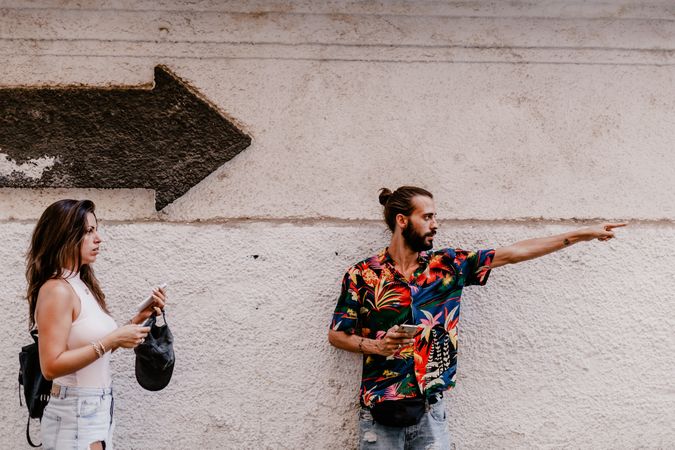 Couple searching for direction while strolling on street