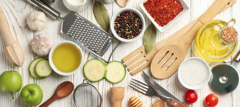 Composition with kitchen cutlery and ingredients for cooking on wooden background, top view