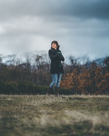 Young woman standing in autumn field