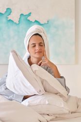 Dreamy woman with eyes closed in bedroom