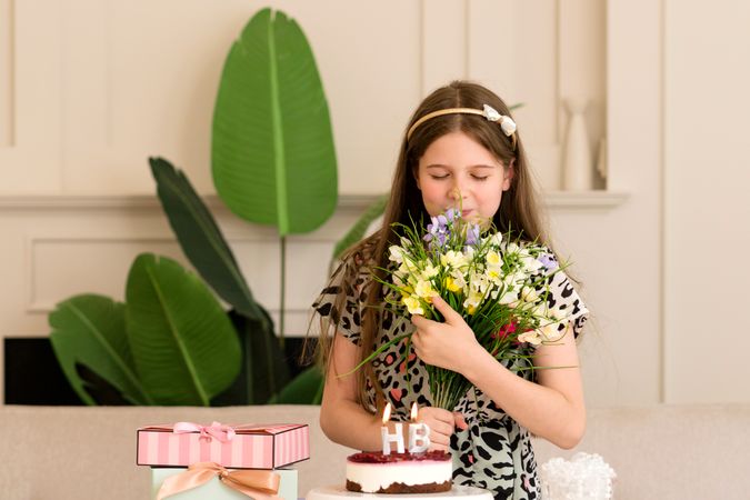 Girl with bouquet of flowers, looking thoughtful