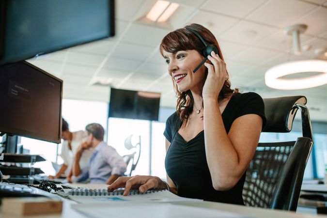 Smiling business woman talking on headset