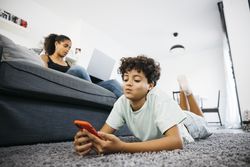 Mother and her daughter sitting on sofa