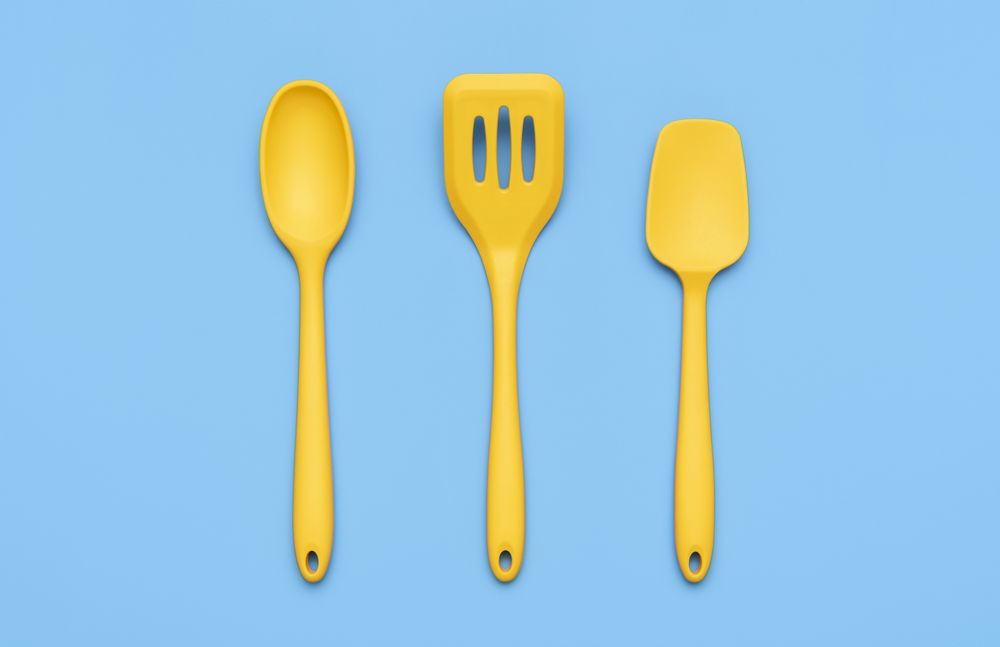 Yellow kitchenware set isolated on blue background above view
