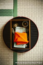 Top view of Japanese tea ceremony equipment on a bamboo mat 0WJL1b