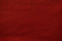 Detailed red knitted fabric background texture.
