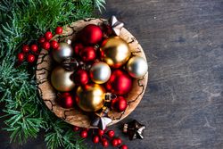Christmas card concept of bowl of golden and red ornaments