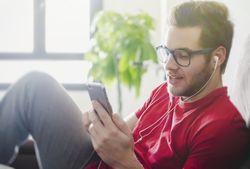 Happy man listening to music on couch