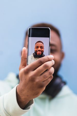 Happy man taking selfie on smartphone