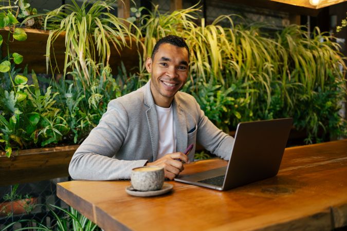 Man working on laptop at cafeteria