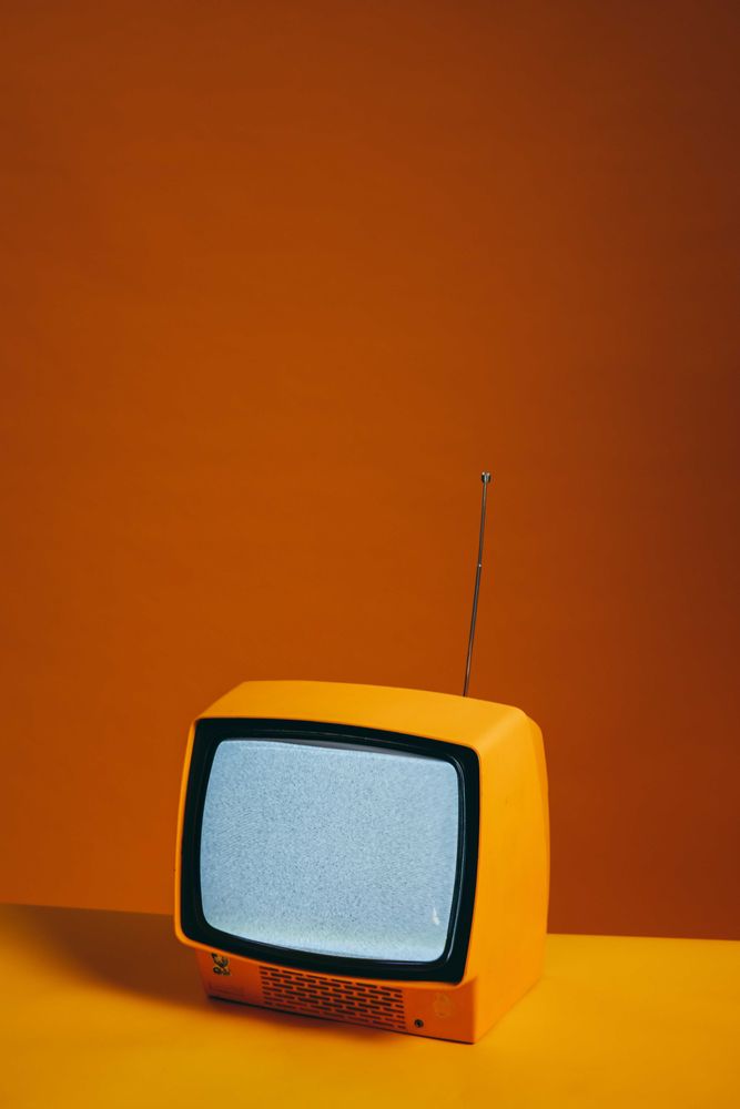 Yellow CRT tv on yellow table