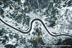 Aerial photo of asphalt road in the middle of snow covered ground 5nvK25