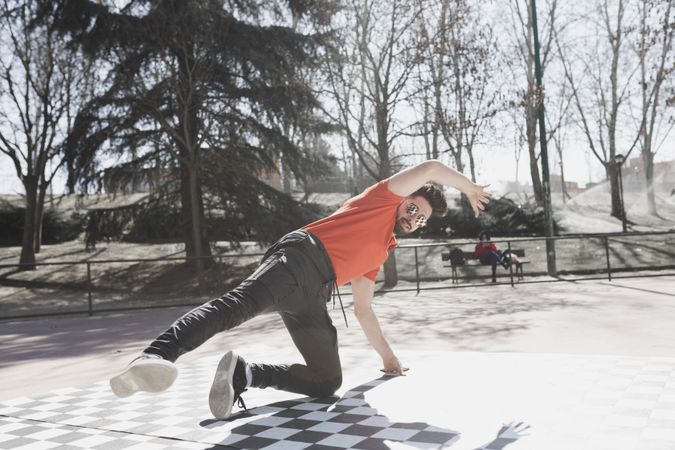 Man dancing break dance in park