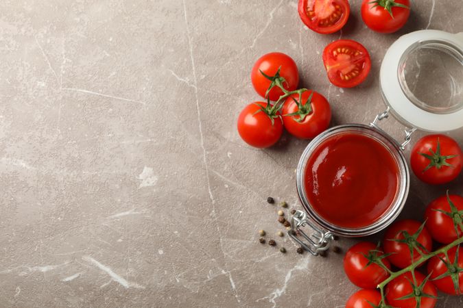 Composition with tomatoes on gray background. Ripe vegetable