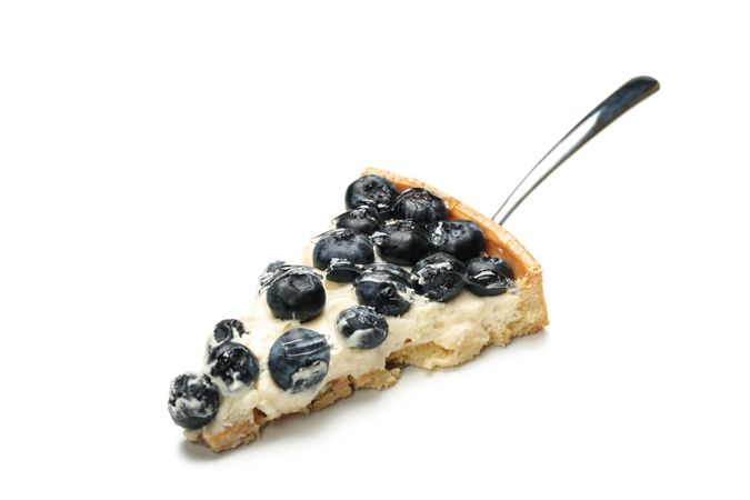 Spatula with blueberry pie slice isolated on light background