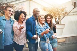 Multi-ethnic group of friends taking a picture of themselves outside