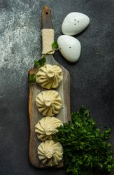 Top view of serving of Georgian khinkali dumplings with cilantro garnish