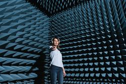 Woman in sound room listening to music