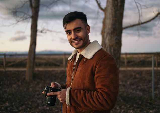 Portrait of a photographer taking photos in the countryside