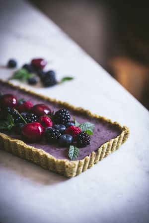 Fresh blueberry pistachio cake with whole berries on top