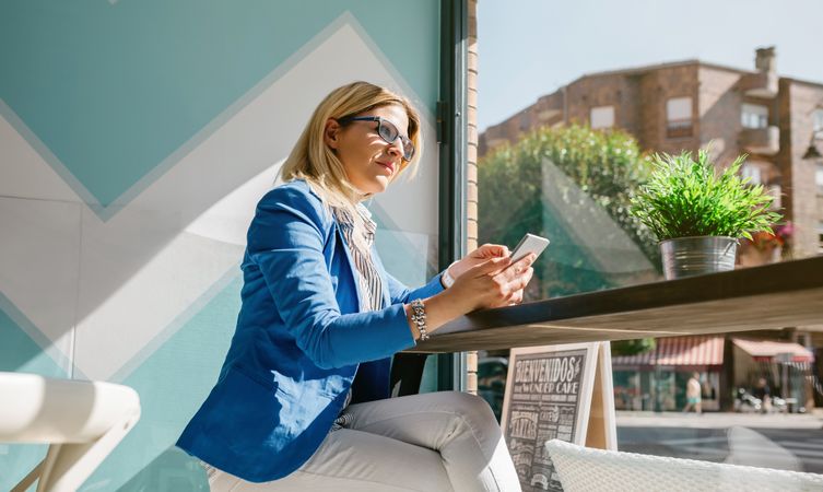 Working woman thinking and holding phone