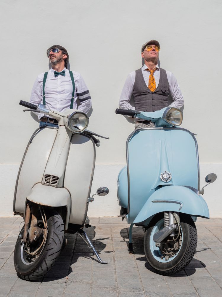 Trendy friends with vintage scooters