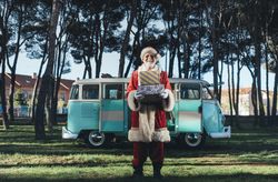 Santa Claus with presents by old van