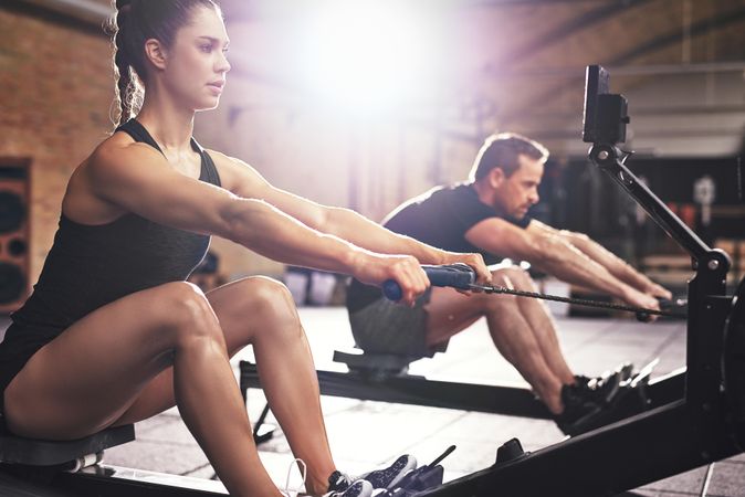 Fit woman concentrating on rowing machine