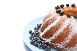 Cake with powder sugar and blueberry isolated on plain background