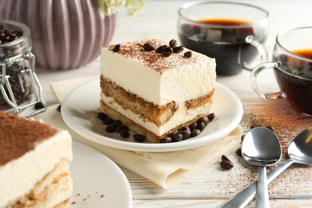 Composition with tasty tiramisu on wooden background. Delicious dessert